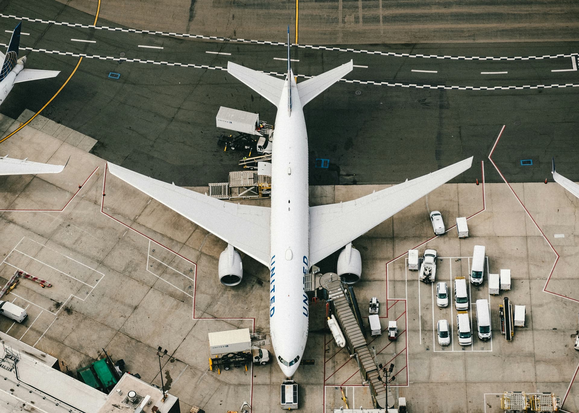 Aircraft on apron with ground service vehicles